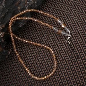 Detailed view of amber faceted beads mobile phone strap with silver lobster clasp