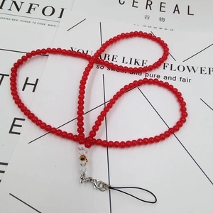 Macro detail of red beaded phone lanyard with lobster clasp and clear crystal accents