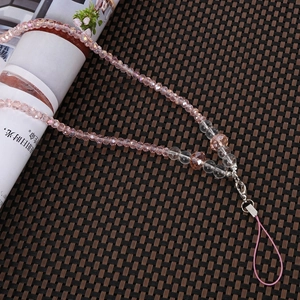 Close-up of pink crystal beaded phone charm with faceted beads and silver metal clasp