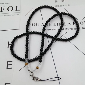 Detail of beaded neck lanyard with black acrylic beads and metal lobster clasp