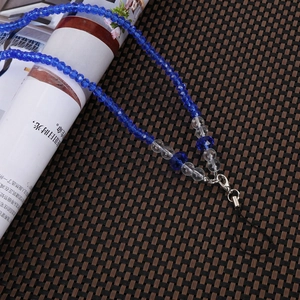 Detailed view of dark blue faceted beaded phone strap with silver lobster clasp