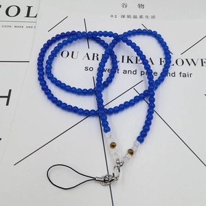 Detail of dark blue crystal beaded phone lanyard with gold accents and metal clasp
