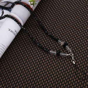 Detail of beaded phone lanyard with faceted black and clear crystal beads and silver clasp
