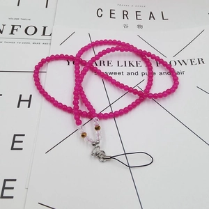 Detail of rose red beaded crystal phone lanyard with golden accents and metal clasp
