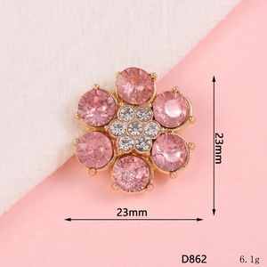 Detail view of a 23mm pink flower pendant with gold plating and crystal accents