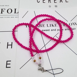 Macro detail of rose pink beaded lanyard with metallic lobster clasp and crystal beads