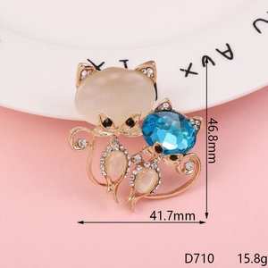 Macro detail of diamond-encrusted fox charm with yellow and sea-blue crystals
