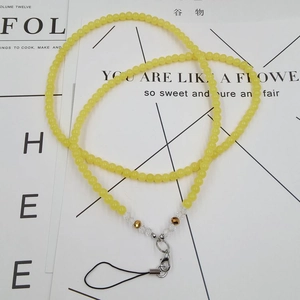 Detail of handmade yellow beaded phone lanyard with crystal beads and metal lobster clasp