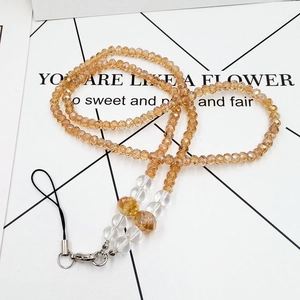 Detail view of multi-colored crystal beaded lanyard with amber facets and metal clasp