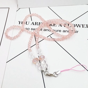 Detail view of pink beaded phone lanyard featuring flower charms and silver metal clasp