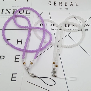 Detailed view of beaded crystal phone lanyards in purple and white with metal lobster clasps