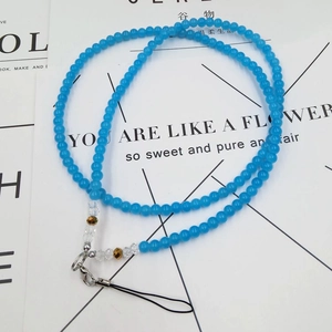 Macro detail of sky blue beaded phone lanyard with crystal accents and lobster clasp