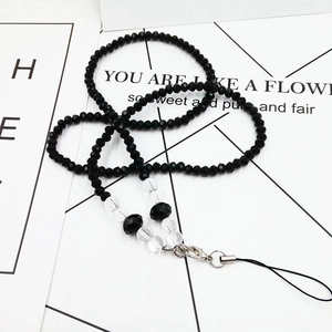 Macro detail of black and clear faceted crystal beaded phone strap with silver clasp
