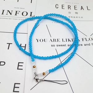 Close-up of sky blue crystal beaded phone lanyard with silver lobster clasp and gold accents