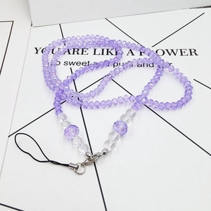 Close-up of purple beaded phone lanyard with resin crystals and metal lobster clasp