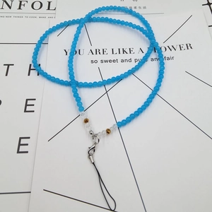 Macro shot of blue beaded phone lanyard with faceted crystals and silver lobster clasp