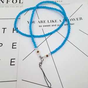 Macro shot of blue beaded phone lanyard with lobster clasp and amber crystal beads