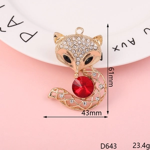 Macro shot of a fox-shaped alloy pendant with rhinestones and a red crystal stone
