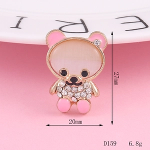 Detail showing the 27mm rhinestone bear charm with cat-eye stone and pink enamel