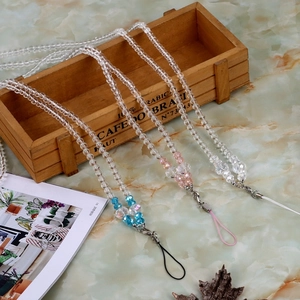 Close-up of beaded phone lanyards in blue, pink and clear colors with metal lobster clasps