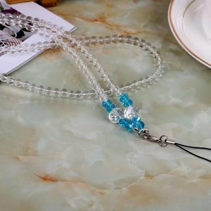 Close-up of pearl crystal beads and blue faceted beads on a universal lanyard chain