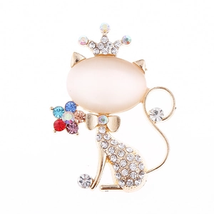 Sparkling cat brooch with beige opal and rhinestone crown on polished gold alloy
