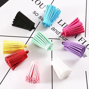 Macro shot of 9 colorful 3cm suede tassels for DIY jewelry and keychain making