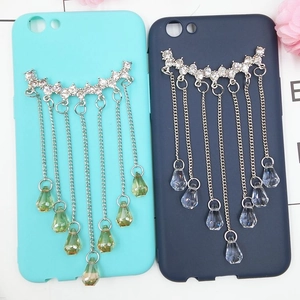 Detailed view of DIY phone cases with silver tassel chains and teardrop crystal pendants