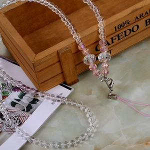 Detailed view of pink crystal beaded phone lanyard with a metal lobster clasp and clear beads