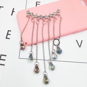 Macro view of silver fringe pendant with crystals and rhinestones for phone cases