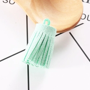 Detailed view of mint green suede tassel pendant for DIY jewelry and keychains