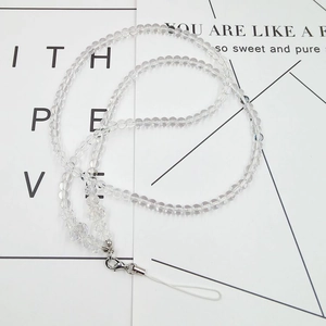 Detail of transparent bead phone lanyard with silver metal clasp on a white background