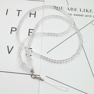 Macro shot of clear faceted crystal beads and silver lobster clasp on a phone strap