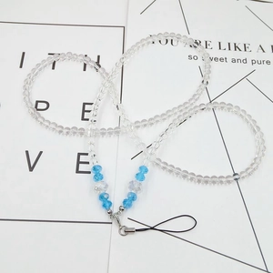 Detail of light blue crystal and transparent bead phone lanyard with silver metal accents
