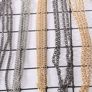 Close-up of assorted metal DIY jewelry chains in gunmetal, silver, and gold finishes