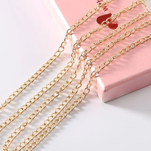 Detailed macro view of parallel bright gold metal chains for DIY jewelry making