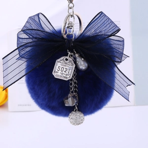 Navy blue faux rabbit fur pom pom keychain with organza ribbon bow and silver charms