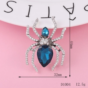 Macro detail of a 44mm silver spider brooch with blue crystals and dimensions shown