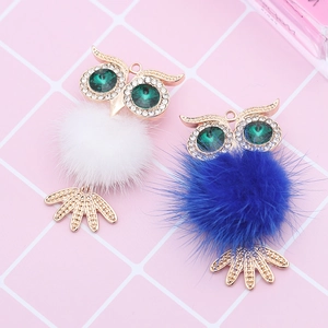 Detailed view of creative owl pendants with fluffy faux fur pom-poms and gold alloy accents