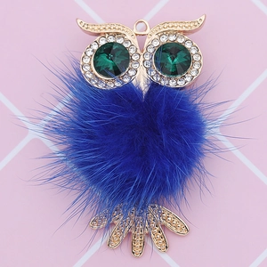 Close-up of alloy owl charm with blue faux fur body and sparkling crystal accents