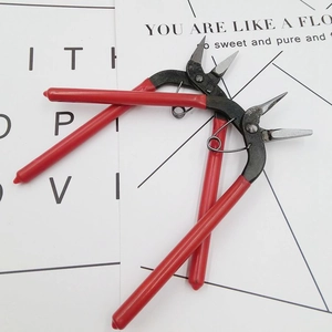 Close-up of DIY jewelry pliers set with red non-slip handles for handmade crafting