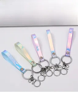 Close-up of holographic leather keychains in pastel colors with silver lobster clasps