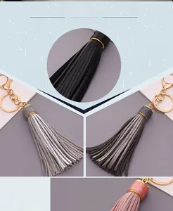 Detailed close-up of colorful PU leather tassel keychains with golden metal lobster clasps