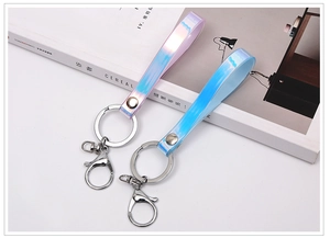 Detail of pink and blue iridescent laser leather keychains with silver lobster clasps