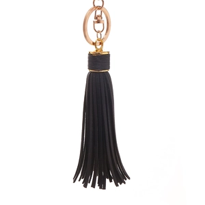 Detail of black leather tassel keychain with rose gold metal ring and spring clasp