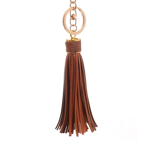 Detail view of a dark brown leather tassel keychain with gold lobster clasp and ring