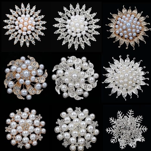 Collection of nine pearl and rhinestone flower brooches in gold and silver plating