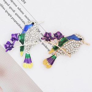Detail showing two colorful hummingbird pins with crystal pavé and enamel inlay on alloy