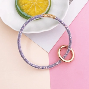 Close-up of a purple glitter jelly ring keychain with rose gold circular metal carabiner