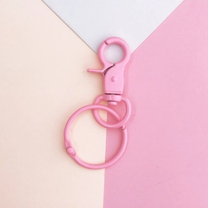 Detailed view of pink coated lobster clasp and round keyring for DIY jewelry making